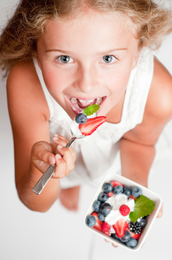 Girl Eating Yogurt with Berries