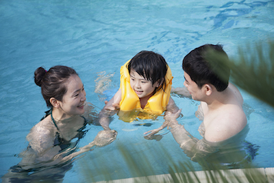 Parents swimming with child