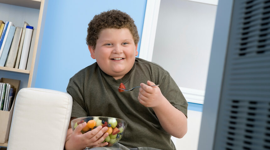 Kid eating a bowl of fruit