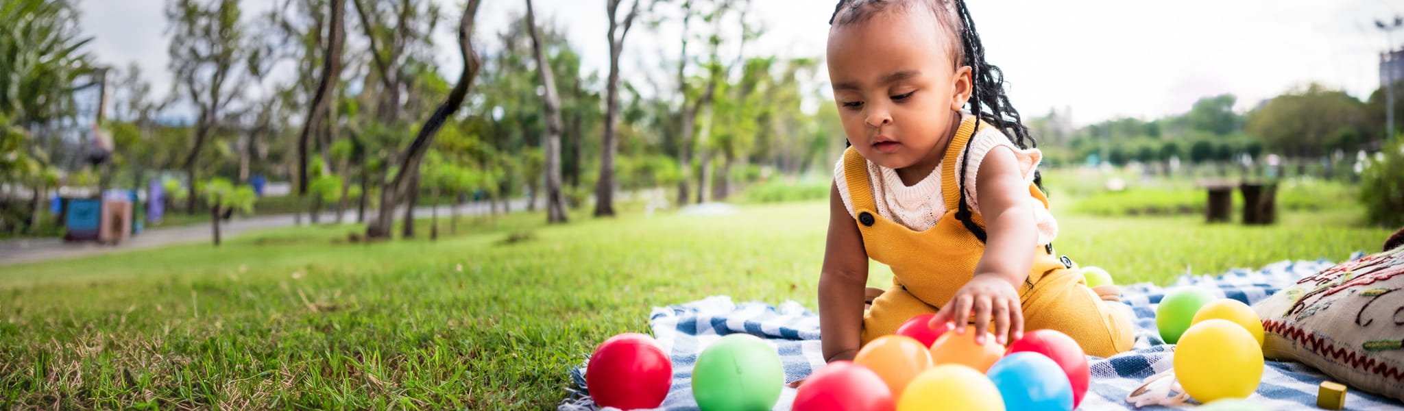 little girl playing with toy balls