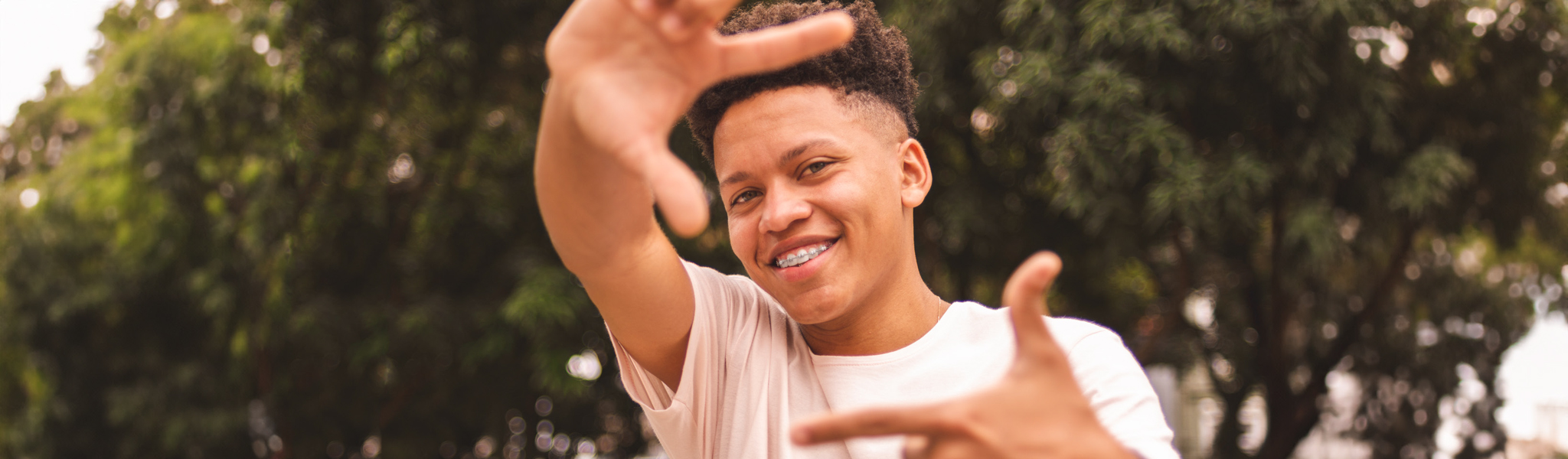 boy with hands out in the shape of a square