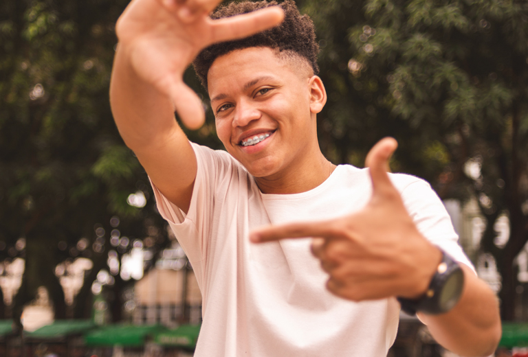 boy with hands out in the shape of a square