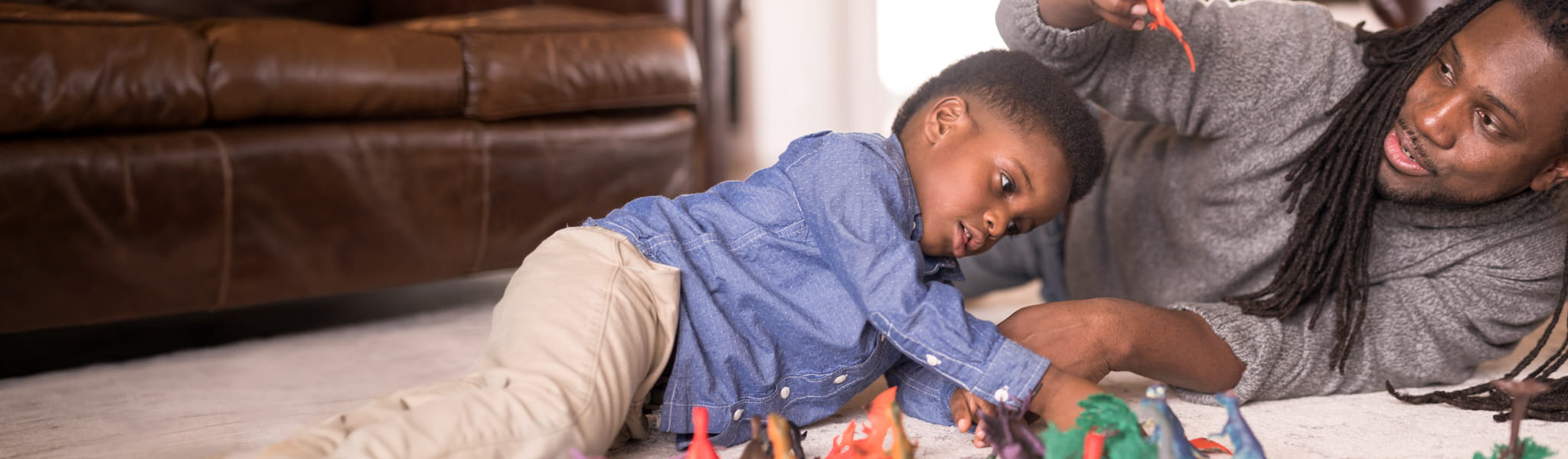 Father and son playing with toys together