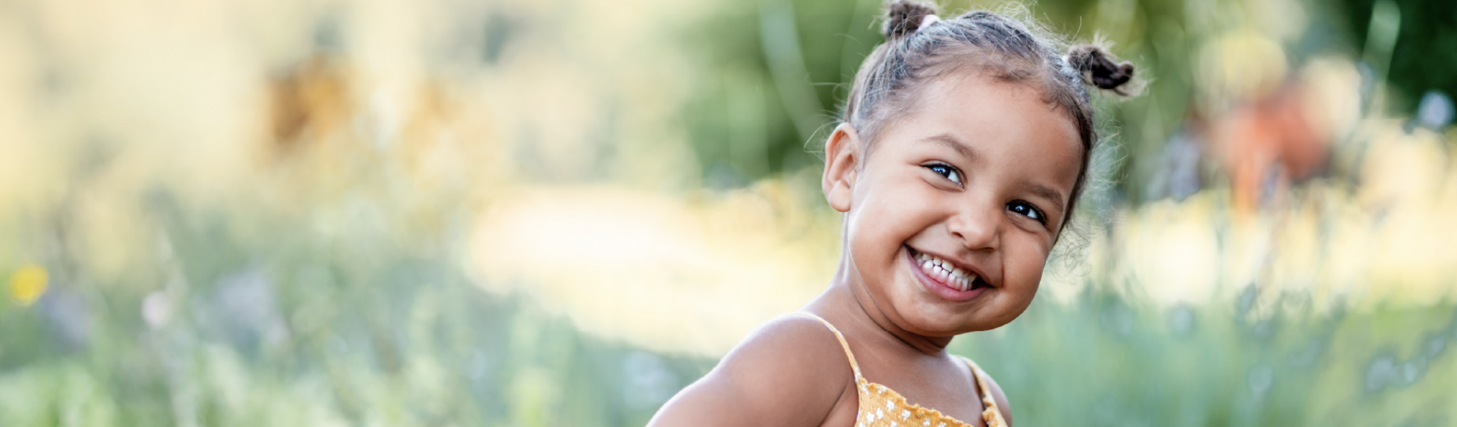 Little girl smiling in park