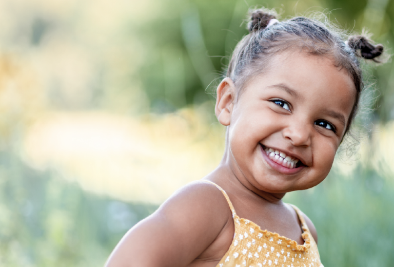 Little girl smiling in park