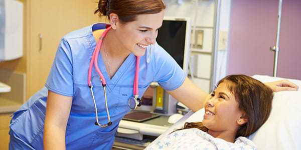 Young girl talking to nurse