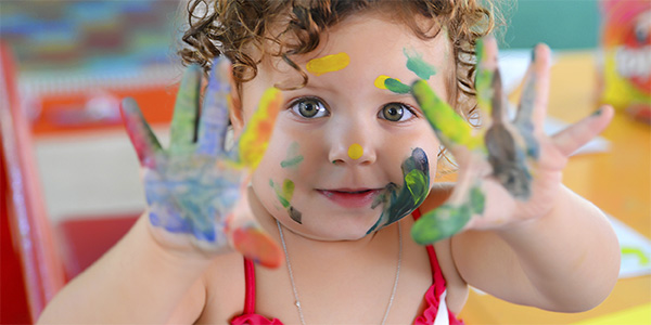 Toddler with finger paints