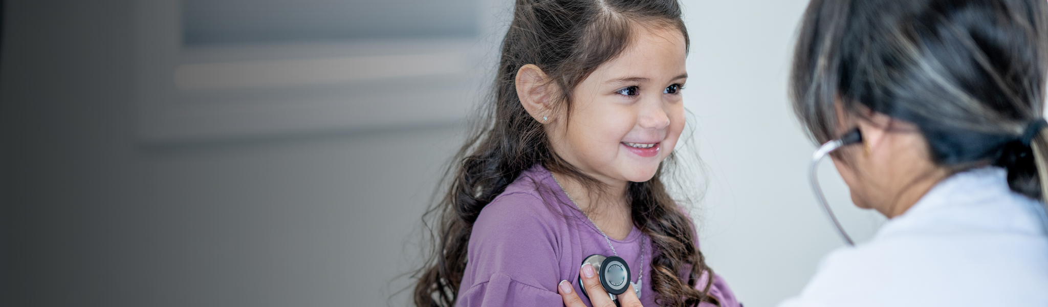 Doctor checking up on a little girl
