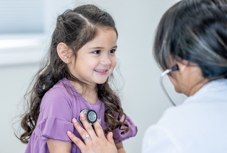 Doctor checking up on a little girl