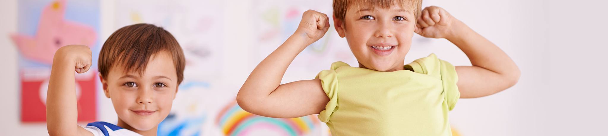 Two children flexing muscles