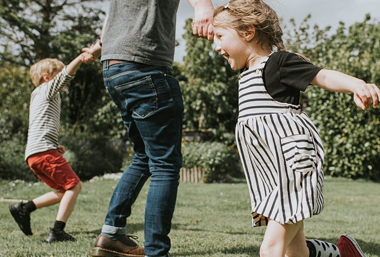 Father playing with two children