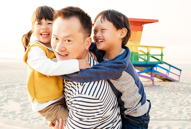 Father and two kids at the beach