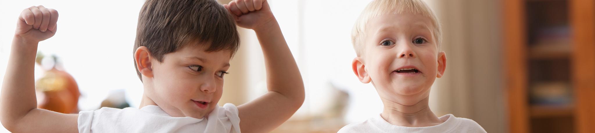 Two boys flexing muscles
