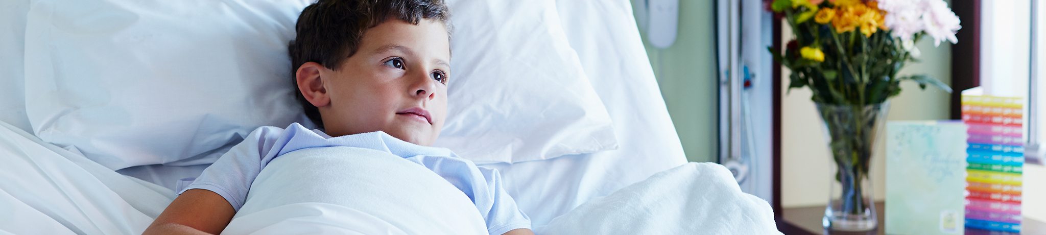 Boy laying in hospital bed