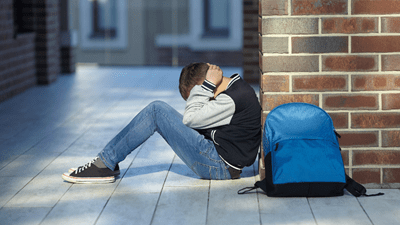 Boy cries in school hallway