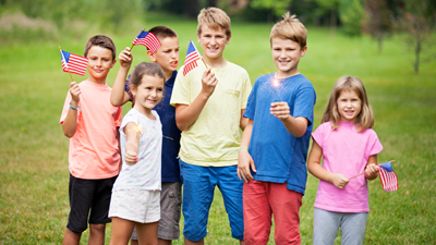 Kids hold American flags