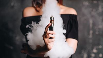 young woman holding a vaporizer