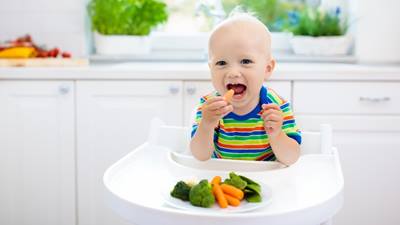 Baby boy eating vegetables