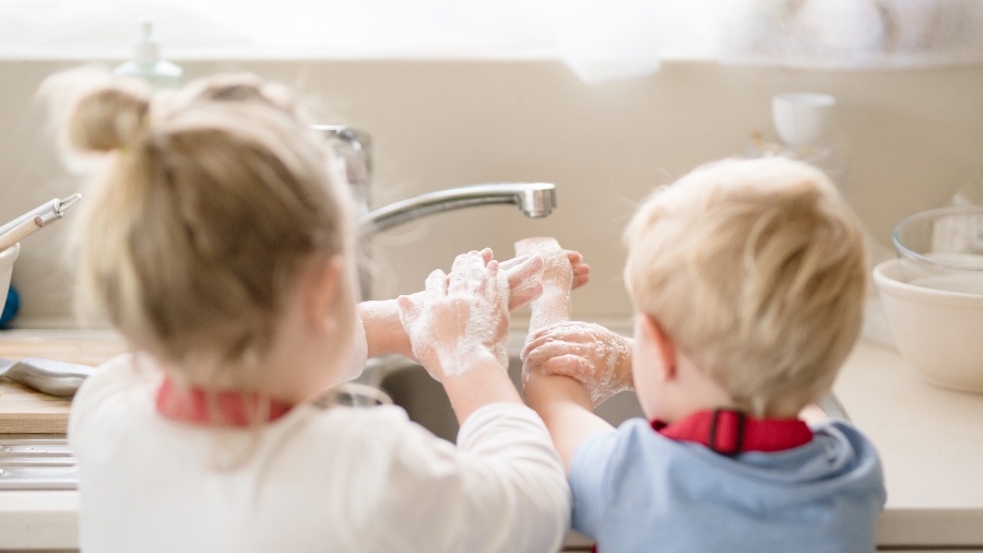 Brother and sister washing hands