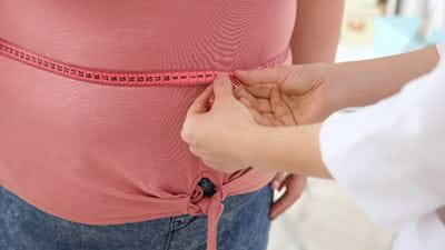 Doctor measuring obese woman