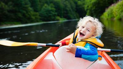 Little boy in kayak with life vest