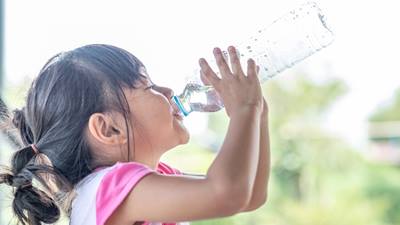Little girl drinking from water bottle