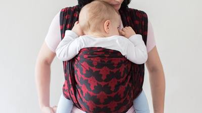 Mother carrying baby in carrier
