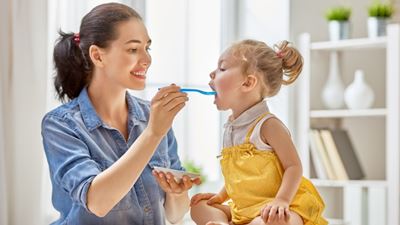 Mother feeding daughter