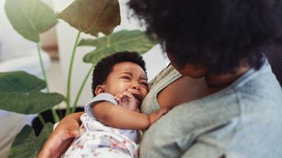 Mother holding crying baby