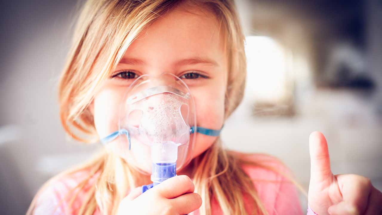Young girl using a nebulizer