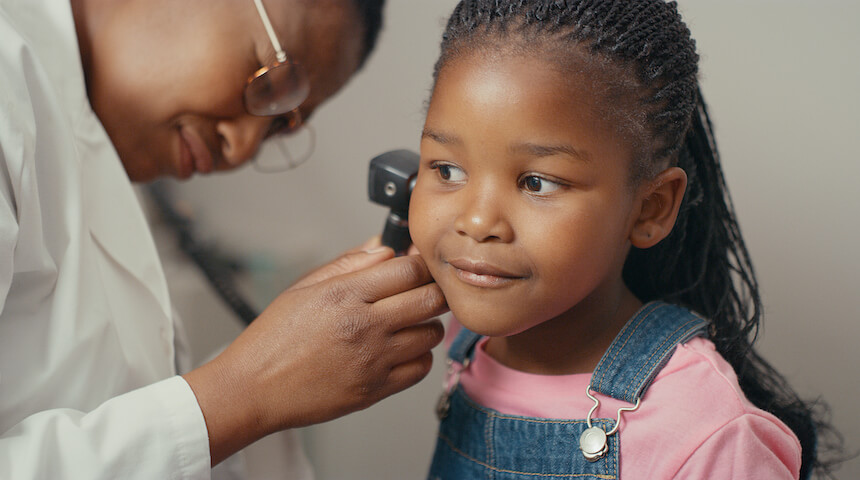 Doctor examining child's ear