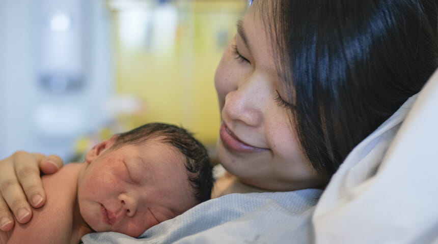 Mother with newborn sleeping on chest