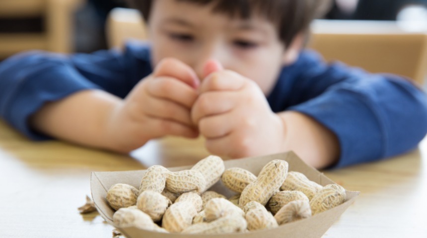 Boy opening peanut