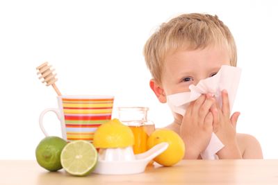 Boy blowing his nose with a cold