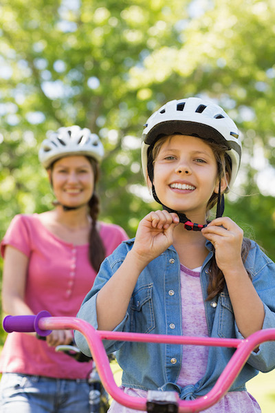 Girl Putting on Bike Helmet
