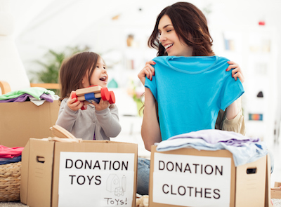 Mom and Daughter Donating Toys and Clothes