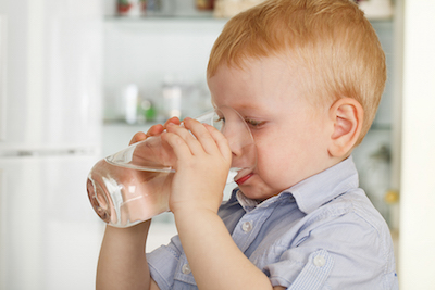 Boy Drinking from Water Glass