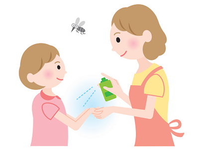 Mom spraying insect repellent on daughter