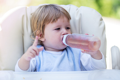 Baby with Bottle of Fruit Juice