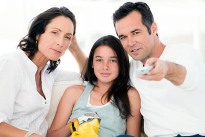 Parents Watching TV with Teenage Daughter