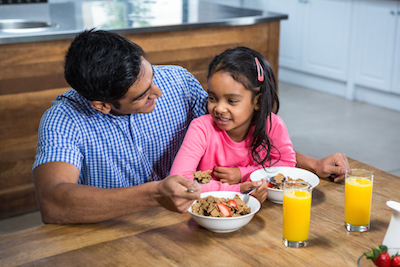 Father and Daughter Having Breakfast