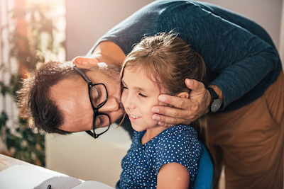 Dad Kissing Daughter for a Job Well Done