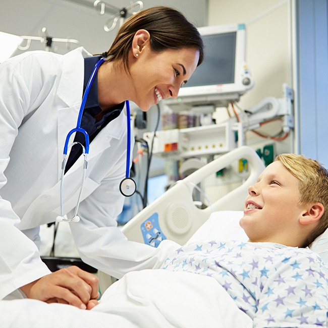 Emergency physician with child in bed.