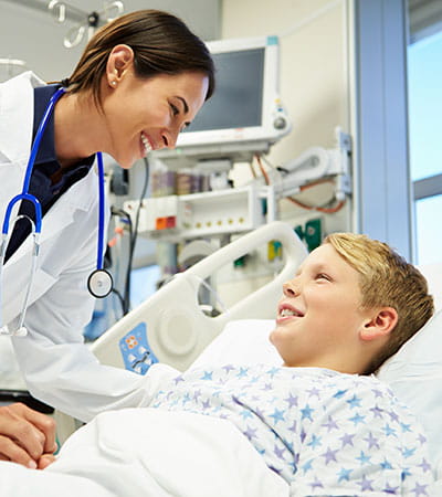 Emergency physician with child in bed.