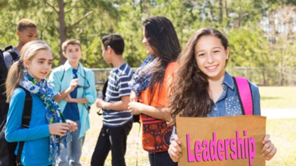 Girl holding leadership sign