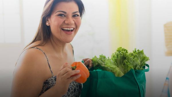 Overweight woman with grocery bag