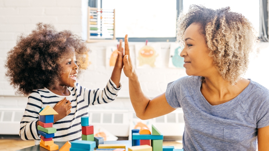 Mother and daughter high-fiving