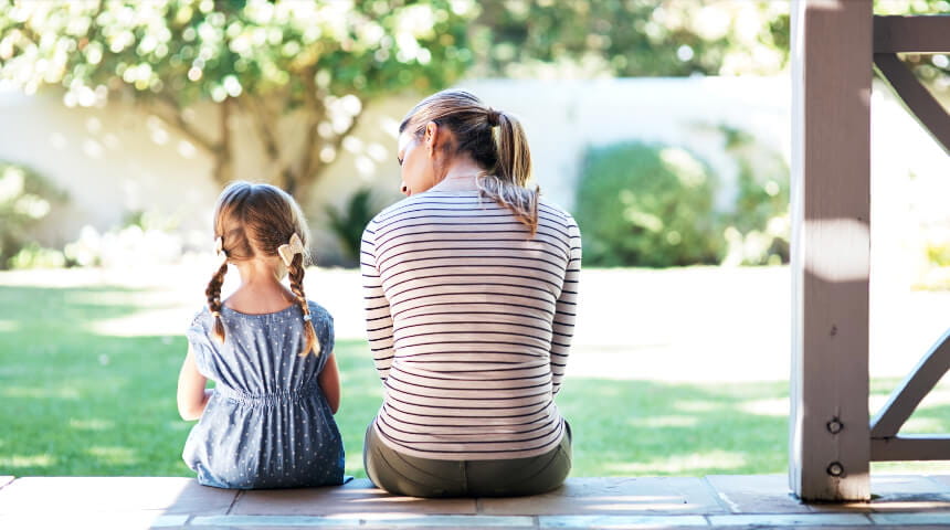 Mom and daughter sitting on porch
