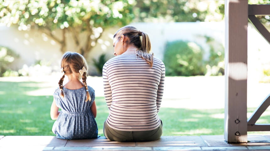 Mom and daughter sitting on porch