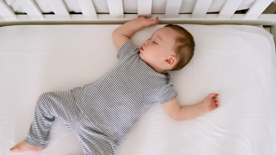 Baby boy sleeping in crib